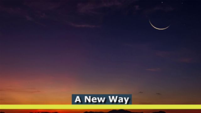 A tranquil twilight sky featuring a gradient from vibrant yellow to deep blue over a silhouette of mountainous terrain. A slim crescent moon is visible near the top, enhancing the serene nocturnal atmosphere. Centered text in the image reads &ldquo;A New Way.&rdquo; Opens a new window with the video.