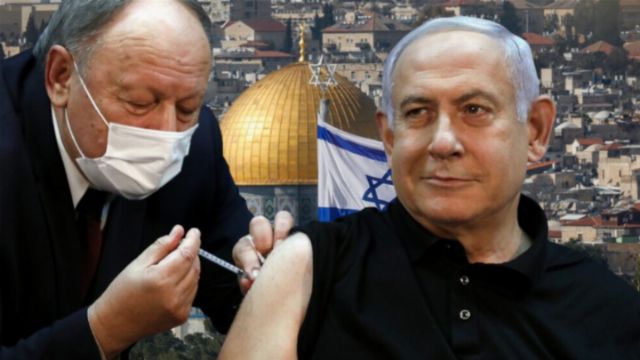 An older man in a black shirt receiving a vaccine from a medical professional in a white mask, with the Dome of the Rock and an Israeli flag in the background, symbolizing health initiatives in a historic setting. Opens a new window with the video.