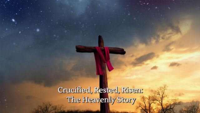 An image depicting a wooden cross with a draped red cloth, standing against a dramatic twilight sky filled with stars. Caption reads &ldquo;Crucified, Rested, Risen: The Heavenly Story.&rdquo; Opens a new window with the video.