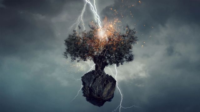 A surreal scene featuring a tree with bright, fiery bursts growing on a large rock. Lightning strikes illuminate dark storm clouds in the background, creating a dramatic atmosphere. Opens a new window with the video.