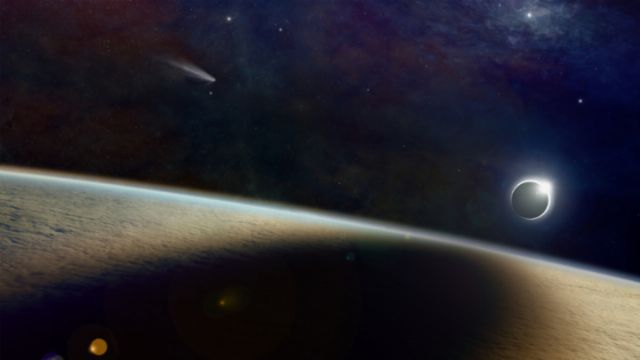 An artistic depiction of celestial phenomena, highlighting the curvature of an Earth-like planet in the foreground, with a solar eclipse seen at a distance over its horizon, while a comet streaks past amidst a star-filled galactic backdrop. Opens a new window with the video.
