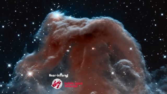 Image of a celestial cloud formation captured in near-infrared by the Hubble Space Telescope, showcasing swirling nebulas and bright stars. Opens a new window with the video.