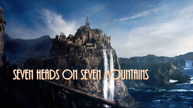 An illustrious castle perched atop a steep cliff with a cascading waterfall, overlooking a turbulent ocean under a cloudy sky. The image includes the text &ldquo;SEVEN HEADS ON SEVEN MOUNTAINS&rdquo; in bold letters. Opens a new window with the video.