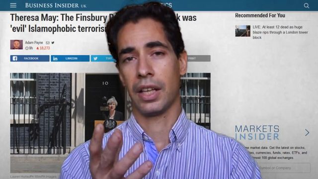 A man is speaking emphatically in a video interview, gesturing with his hand. He is outdoors with a blurred building in the background, likely a governmental or office building. Above him in the video, a banner reads &ldquo;Theresa May: The Finsbury Park attack was 'evil' Islamophobic terrorism&rdquo; on the Business Insider UK website. Additional smaller video options and stock market updates are shown on the right side of the screen. Opens a new window with the video.