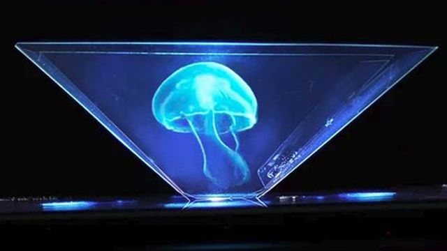 A luminous blue jellyfish is encapsulated within a triangular prism against a dark background, with soft blue light emanating from the base of the prism. Opens a new window with the video.