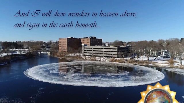 A winter landscape featuring a frozen river and a circular ice formation in the foreground, with buildings in the background under a clear blue sky. A biblical verse overlays at the top stating, &ldquo;And I will shew wonders in heaven above, and signs in the earth beneath.&rdquo; Opens a new window with the video.